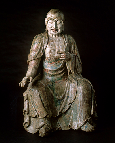 photo of seated luohan made of wood gesso and polychrome facing camera head on