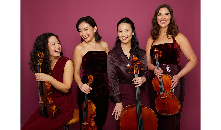 photo of quartet of string musicians holding their instruments against a maroon backdrop