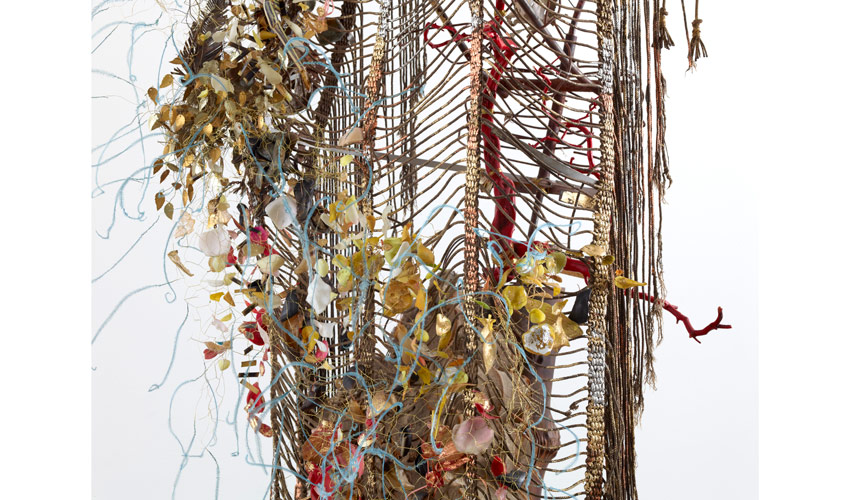 detail photo of 3d abstract work standing up on the floor suggesting a human frame overgrown with organic detritus