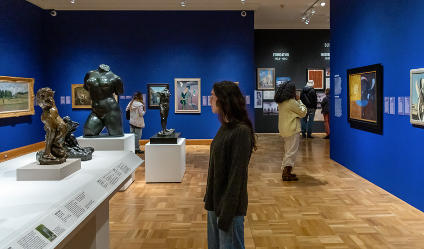 patrons in a gallery looking at artwork