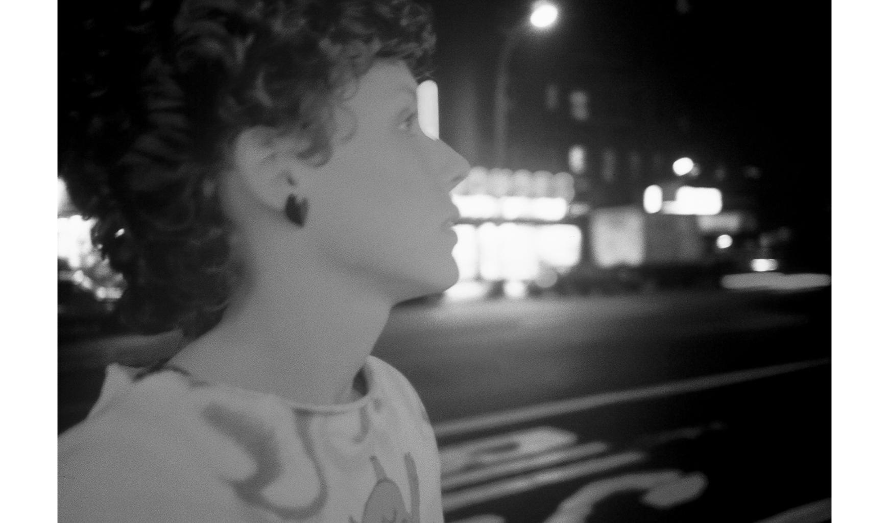 close up black and white photo of the artist Jane Dickson on the street in profile looking away