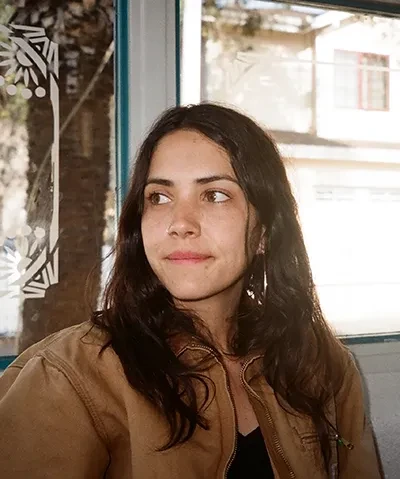 photo of woman in front of a window looking away from camera