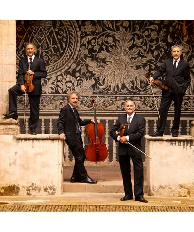 photo of four musicians holding their string instruments standing in a U formation on some steps outside an old building with columns