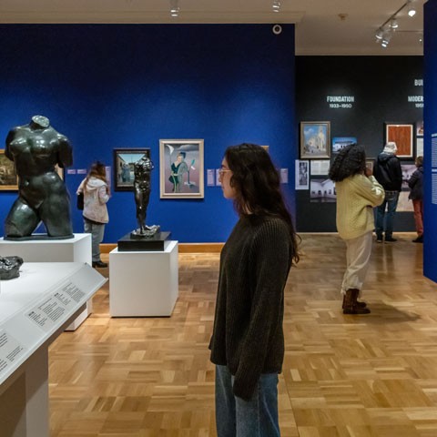 patrons in a gallery looking at artwork