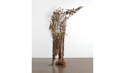 detail photo of 3d abstract work standing up on the floor suggesting a human frame overgrown with organic detritus