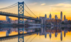 Philadelphia sunset skyline and Ben Franklin Bridge refection from across the Delaware River